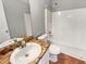 Bathroom with tub-shower combo and vanity sink, showcasing a clean and functional space at 46 Norman Rd, Covington, GA 30014