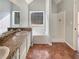 Bathroom featuring a vanity with tub and shower, with a large window for natural light at 46 Norman Rd, Covington, GA 30014