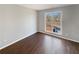 Bright bedroom with a large window, hardwood floors, and fresh, neutral paint at 46 Norman Rd, Covington, GA 30014