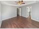 Spacious bedroom with hardwood floors and tray ceilings, featuring two doorways at 46 Norman Rd, Covington, GA 30014