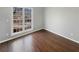Cozy bedroom with hardwood floors and a large window for natural light and street views at 46 Norman Rd, Covington, GA 30014