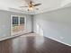 Bright bedroom with large window and tray ceilings, showing natural light and hardwood floors at 46 Norman Rd, Covington, GA 30014