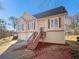 Charming two-story house with beige siding, dark roof, two-car garage and inviting front entrance at 46 Norman Rd, Covington, GA 30014