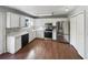 Spacious kitchen features granite counters, stainless appliances, white cabinets, and hardwood floors at 46 Norman Rd, Covington, GA 30014
