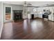 Open-concept kitchen with white cabinets, stainless steel appliances, granite countertops, and hardwood floors at 46 Norman Rd, Covington, GA 30014