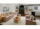 Staged living room featuring a fireplace, neutral furniture, hardwood floors, and lots of natural light at 46 Norman Rd, Covington, GA 30014