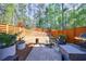 Inviting backyard with Adirondack chairs, grill, modern horizontal fence, and patio area at 5010 Towneship Creek Rd, Roswell, GA 30075