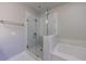 Bathroom featuring a glass shower and soaking tub at 5010 Towneship Creek Rd, Roswell, GA 30075