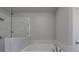 Modern bathroom with a soaking tub and marble-like tile surround at 5010 Towneship Creek Rd, Roswell, GA 30075