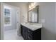 Bathroom featuring a vanity, a window, and a marble-like tile floor at 5010 Towneship Creek Rd, Roswell, GA 30075