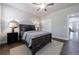 Cozy bedroom featuring hardwood floors, neutral walls, ceiling fan, and carpet at 5010 Towneship Creek Rd, Roswell, GA 30075