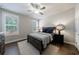 Bedroom with a bed, two windows, and hard wood floors at 5010 Towneship Creek Rd, Roswell, GA 30075