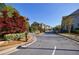 Street view of a charming townhome community with landscaped front yards and attractive exteriors at 5010 Towneship Creek Rd, Roswell, GA 30075