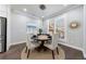 Bright dining area with a modern chandelier, seating for four, and large windows at 5010 Towneship Creek Rd, Roswell, GA 30075