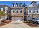 Charming brick townhome with a two-car garage, dormer windows, and well-maintained landscaping at 5010 Towneship Creek Rd, Roswell, GA 30075