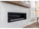 Modern fireplace with decorative tile and wood mantle at 5010 Towneship Creek Rd, Roswell, GA 30075