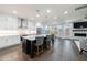 Open-concept kitchen featuring white cabinets, quartz countertops, stainless steel appliances, and a center island with seating at 5010 Towneship Creek Rd, Roswell, GA 30075