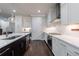 Bright kitchen featuring white cabinets, quartz countertops, stainless appliances, and an eat-in island at 5010 Towneship Creek Rd, Roswell, GA 30075