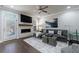 Comfortable living room featuring a fireplace, large windows, and a cozy seating area at 5010 Towneship Creek Rd, Roswell, GA 30075