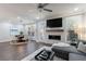Open-concept living room with a fireplace, dining area, and plenty of natural light at 5010 Towneship Creek Rd, Roswell, GA 30075