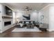 Bright living room boasts a sleek fireplace, ceiling fan, and modern gray sectional at 5010 Towneship Creek Rd, Roswell, GA 30075