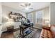 Bright office featuring modern ceiling fan, floating shelves, and hardwood floors at 5010 Towneship Creek Rd, Roswell, GA 30075