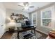 Bright office featuring modern ceiling fan, floating shelves, and hardwood floors at 5010 Towneship Creek Rd, Roswell, GA 30075