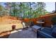Landscaped backyard featuring modern privacy fence, patio, grill, and seating at 5010 Towneship Creek Rd, Roswell, GA 30075