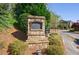 Stone entrance sign for Roswell Township, surrounded by lush greenery and landscaping at 5010 Towneship Creek Rd, Roswell, GA 30075