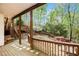 Large wooden back deck overlooking a wooded yard with wooden stairs at 5145 Southlake Dr, Alpharetta, GA 30005