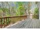 Wooden back deck overlooks an expansive yard with many mature trees and shrubs at 5145 Southlake Dr, Alpharetta, GA 30005