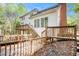 Rear view of house with multi-level wooden deck, stairs, brick chimney and many windows at 5145 Southlake Dr, Alpharetta, GA 30005