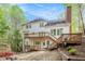 Back exterior of home with multi-tiered wooden deck, stairs and brick chimney at 5145 Southlake Dr, Alpharetta, GA 30005