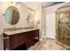 Bathroom featuring a double granite sink vanity and a glass enclosed tile shower at 5145 Southlake Dr, Alpharetta, GA 30005