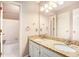 Bright bathroom featuring a double granite sink vanity with tub and shower combo at 5145 Southlake Dr, Alpharetta, GA 30005