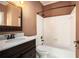 Well-lit bathroom with updated vanity, sink, and shower-tub combination at 5145 Southlake Dr, Alpharetta, GA 30005