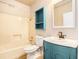 Bathroom with white walls and a blue vanity with a tub and shower combo at 5145 Southlake Dr, Alpharetta, GA 30005