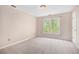 Upstairs bedroom features a window with a yard view and a closet at 5145 Southlake Dr, Alpharetta, GA 30005