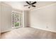 Spacious bedroom with ceiling fan and bright window overlooking the neighborhood at 5145 Southlake Dr, Alpharetta, GA 30005