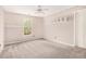 Neutral bedroom features a window view of the yard and built-in shelving at 5145 Southlake Dr, Alpharetta, GA 30005