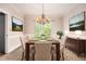 Formal dining room with chandelier, table set for six, and views of the backyard at 5145 Southlake Dr, Alpharetta, GA 30005