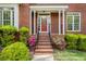 Close-up of home's entryway with brick steps and colorful flower bushes at 5145 Southlake Dr, Alpharetta, GA 30005