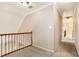 Upstairs hallway with carpet, painted walls and white trim, along with decorative wrought iron at 5145 Southlake Dr, Alpharetta, GA 30005
