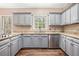 Updated kitchen with granite countertops, stainless steel appliances, and grey cabinets at 5145 Southlake Dr, Alpharetta, GA 30005