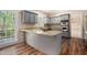 Well-lit eat-in kitchen with stainless steel appliances, granite countertops, and wood flooring at 5145 Southlake Dr, Alpharetta, GA 30005
