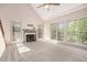 Bright living room features large windows offering view to the outdoors and a fireplace at 5145 Southlake Dr, Alpharetta, GA 30005