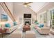 Bright living room with vaulted ceilings, fireplace, and a ceiling fan with abundant natural light at 5145 Southlake Dr, Alpharetta, GA 30005