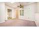 Living room with pink carpet and three doorways leading to other rooms at 5145 Southlake Dr, Alpharetta, GA 30005