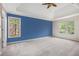 A spacious main bedroom features bright windows and a blue accent wall at 5145 Southlake Dr, Alpharetta, GA 30005