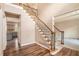 Staircase with iron railings and view of the updated kitchen and living areas at 5145 Southlake Dr, Alpharetta, GA 30005